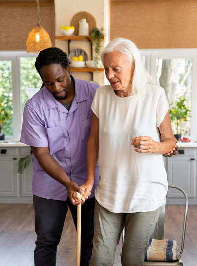Caregiver helping a senior resident walk