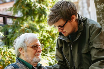 Carer supporting a bedridden resident